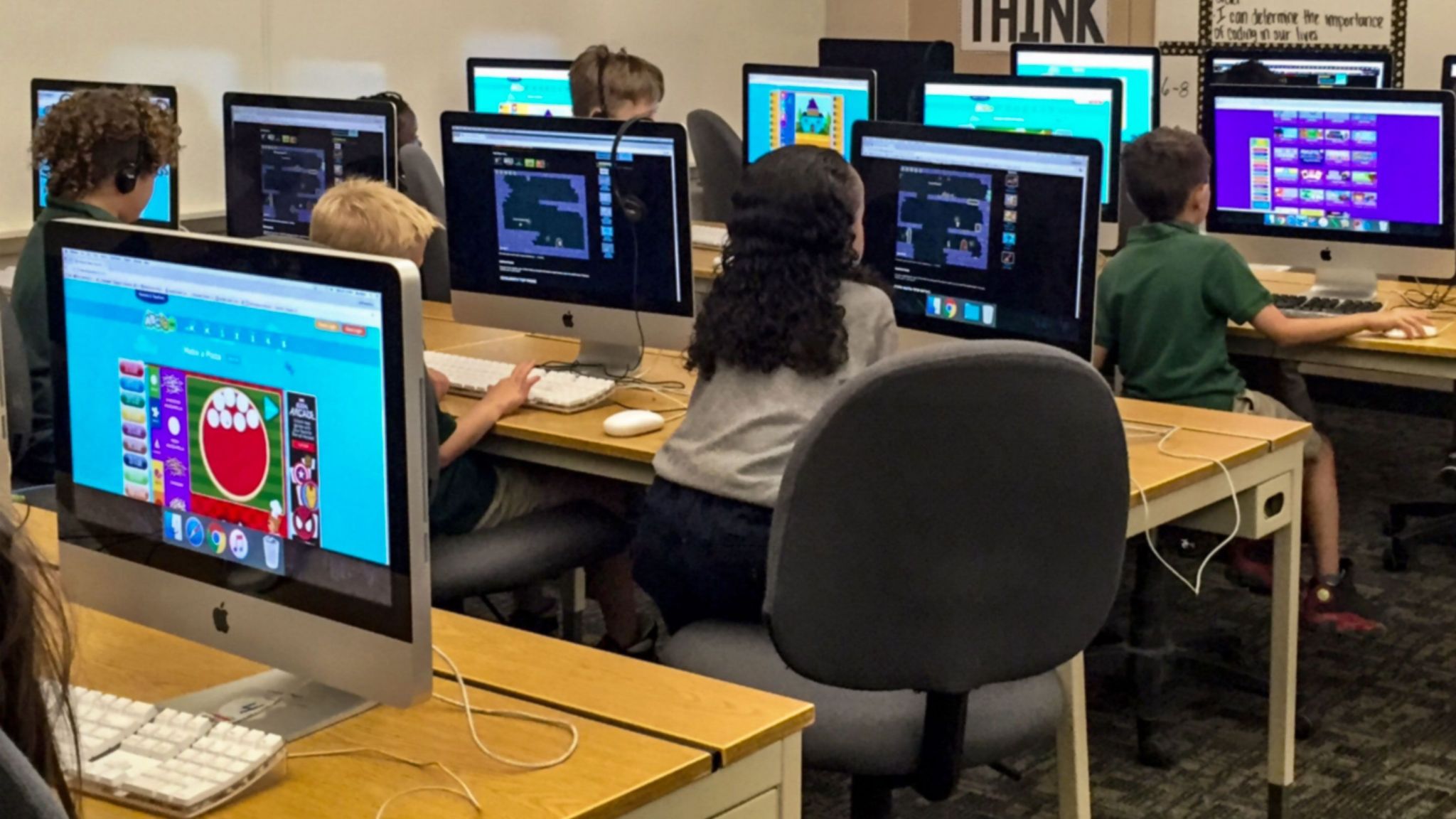 Kids in a classroom use a variety of programs to practice coding
